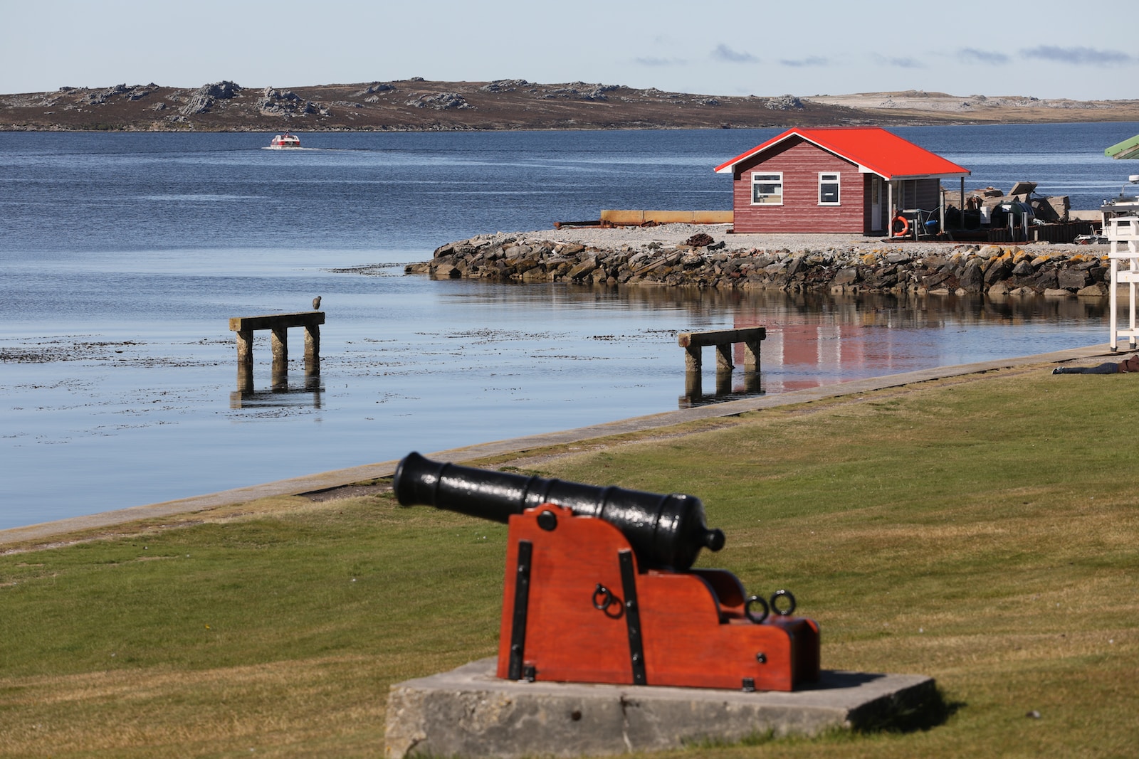 red and white house near body of water during daytime